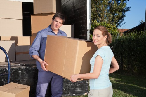 Careful lifting of large furniture during local removals in Burroughs